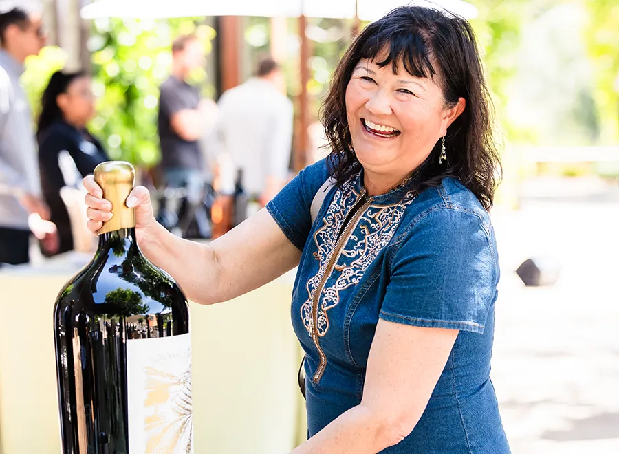 Happy Lady with a huge bottle of Somerston wine.
