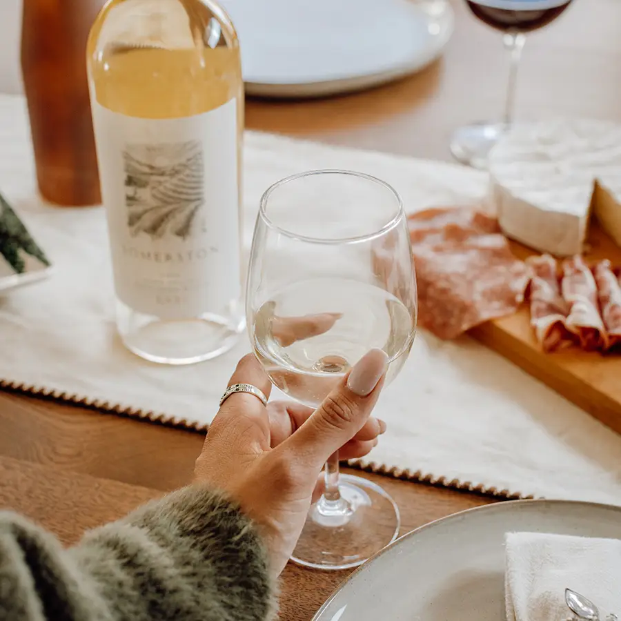 Person reaching for Somerston wines.